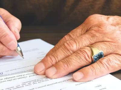 A man signing a will.